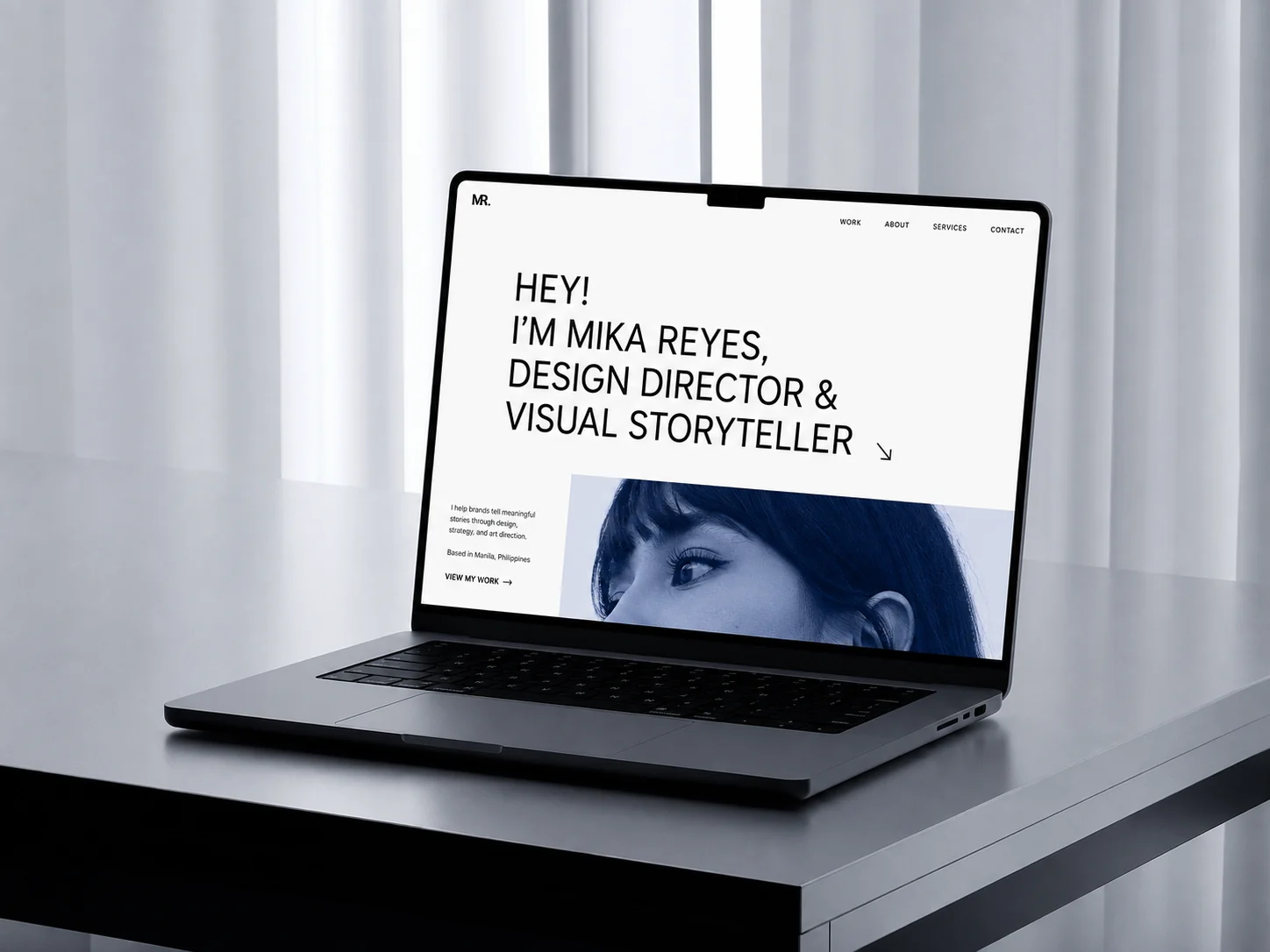 Minimal personal portfolio website displayed on a laptop